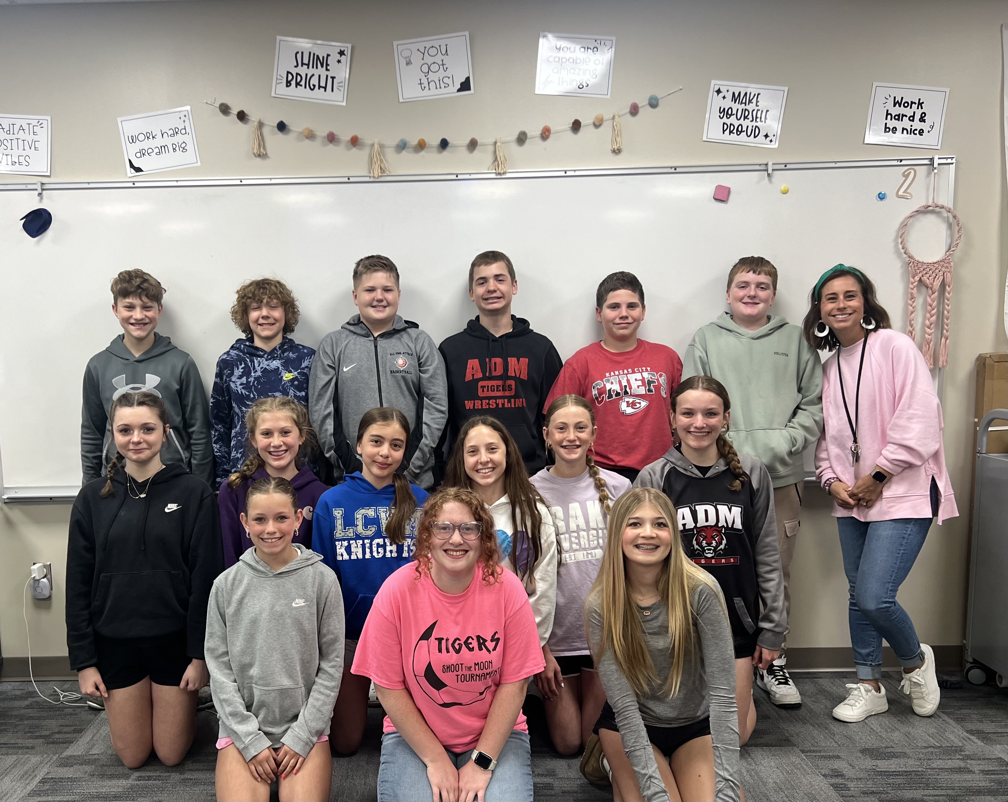 Courtney Stephenson and her 6th grade students smile as a group. They are proud of using the Carnegie Learning Middle School Math Solution and Building Thinking Classrooms.