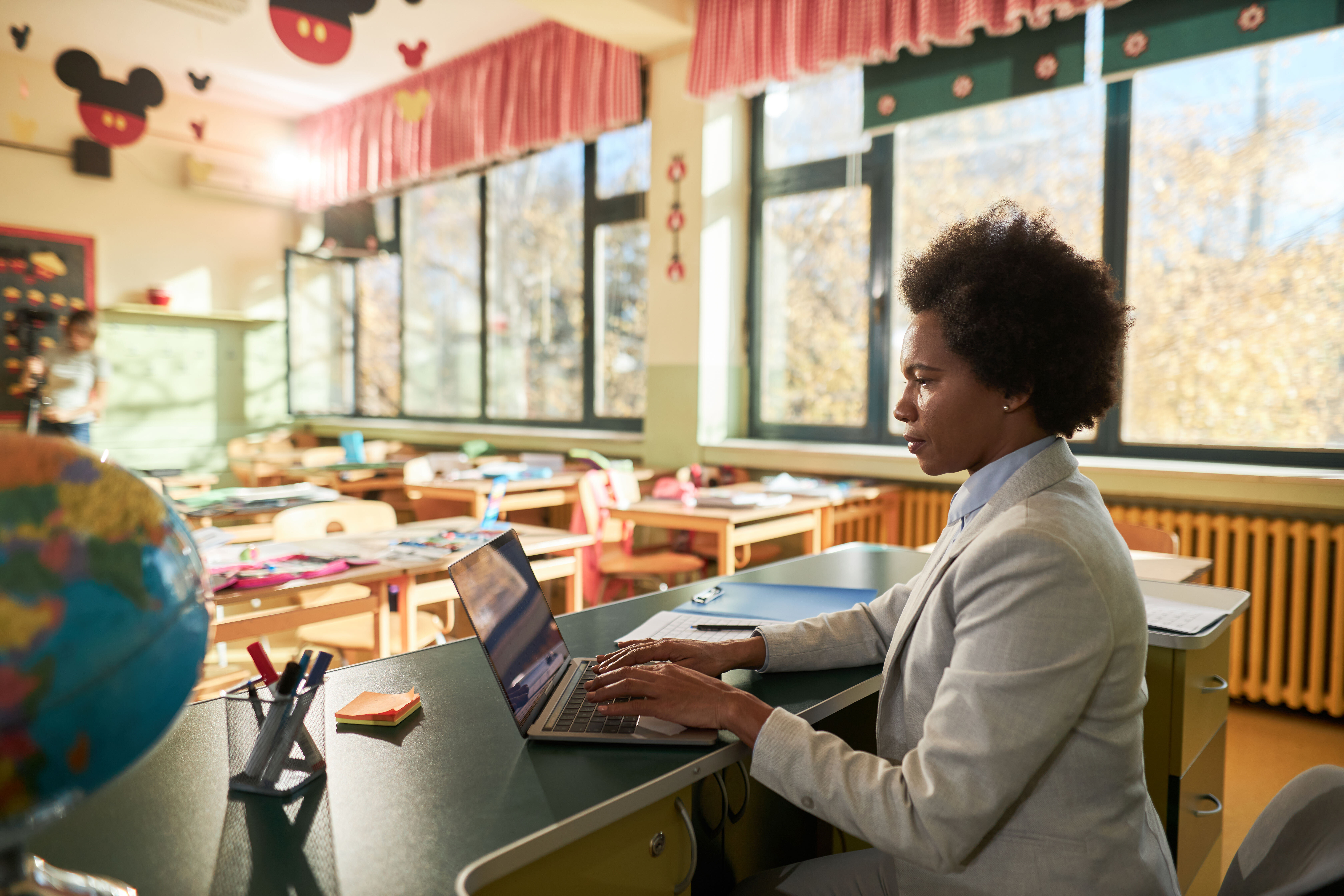 female teacher working on laptop