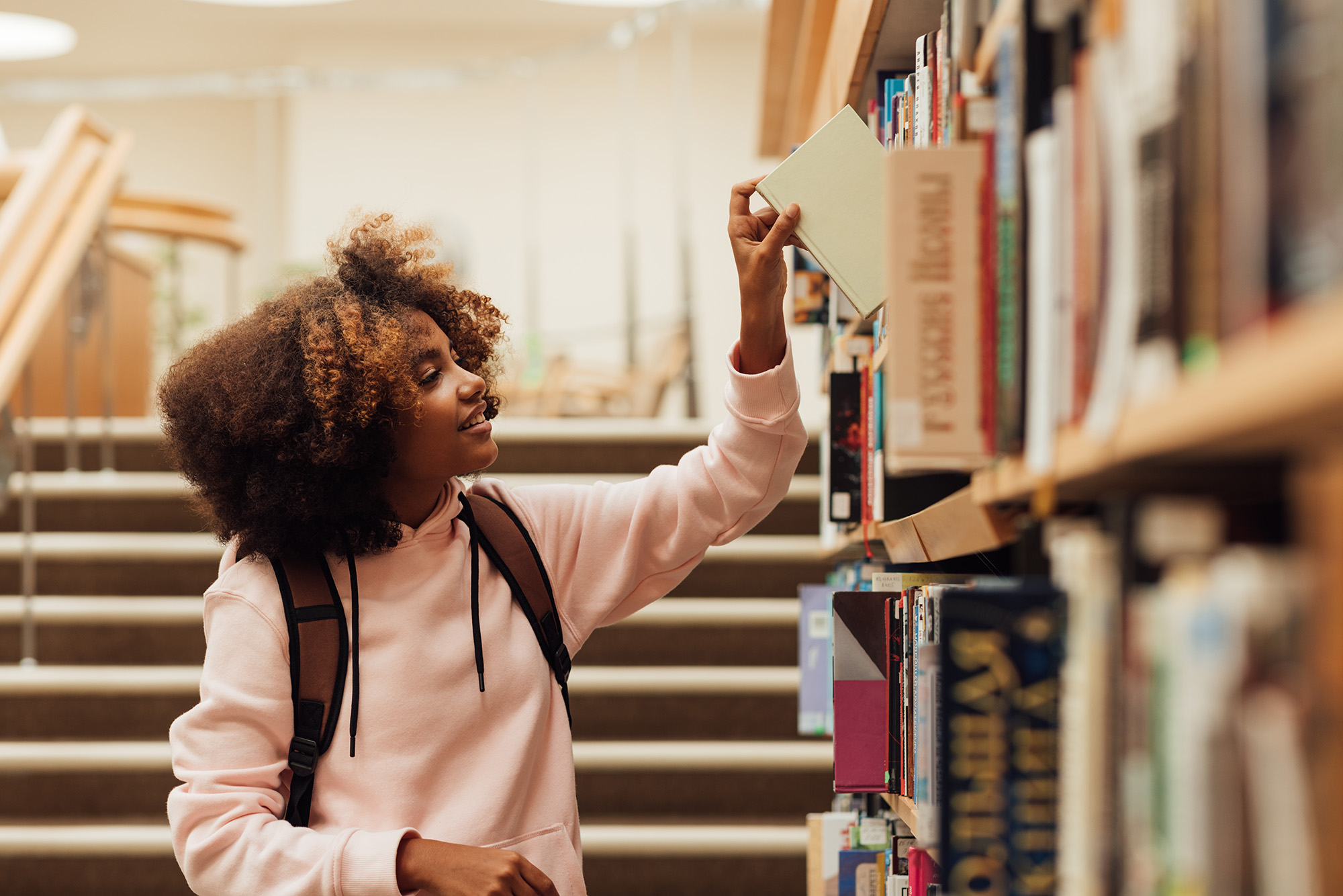 teen in library