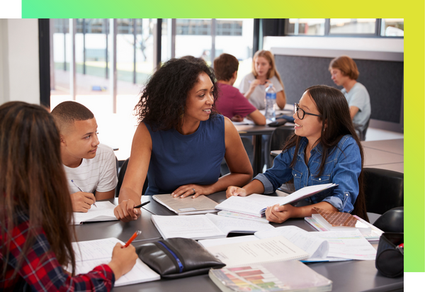 A teacher works with a group of adolescent students