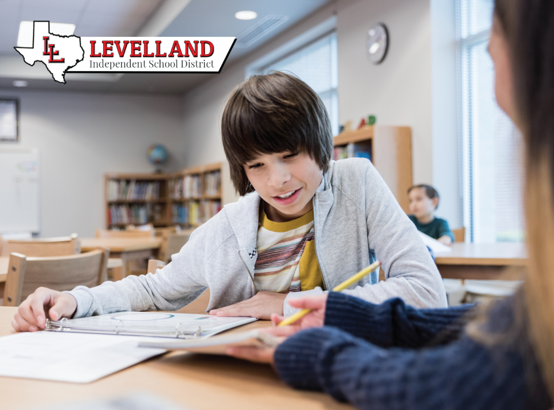 Middle school student sitting at desk looking in a text book and completing their math classwork. The Levelland Independent School District name and logo are in the foreground on the top left.