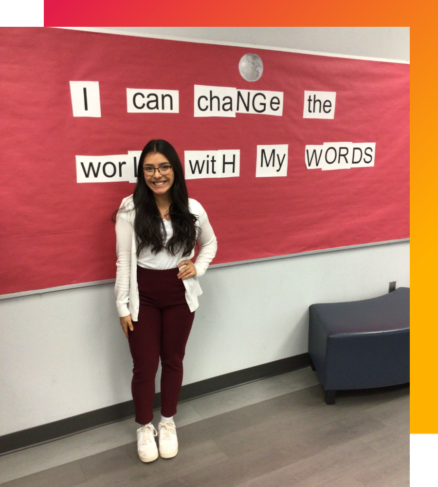 Melissa Lugo is a creative math teacher who stands in front of her red bulletin board. Behind her, the board says, 