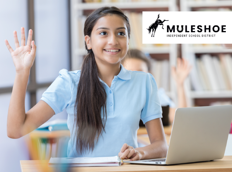 Middle school student sitting at desk in classroom with hand raised with an open laptop in front of her. The Muleshoe Independent School District name and logo are in the foreground on the top right